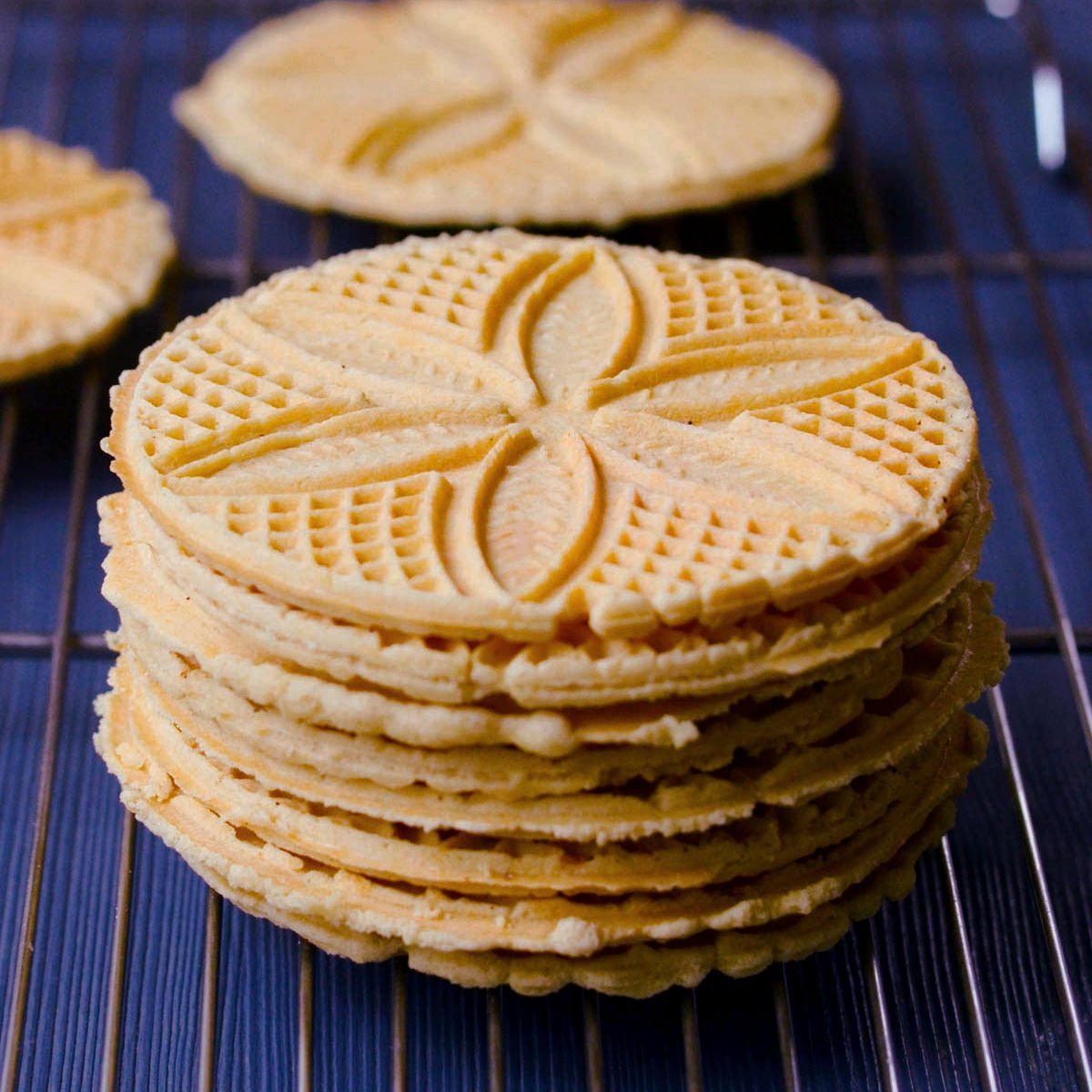 Pizzelles in a stack on a wire rack